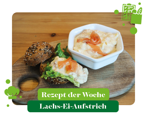 KI generiert: Brot mit Lachsaufstrich auf Holzbrett. Text: "Rezept der Woche Lachs-Ei-Aufstrich".