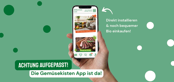 KI generiert: Ein Smartphone zeigt die GemüseKisten-App. Text: "Achtung aufgepasst! Die GemüseKisten App ist da!"