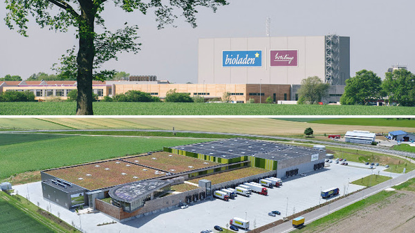 KI generiert: Industriegebäude mit "bioladen" und "Weiling" Logo, umgeben von Feldern und parkenden LKWs.